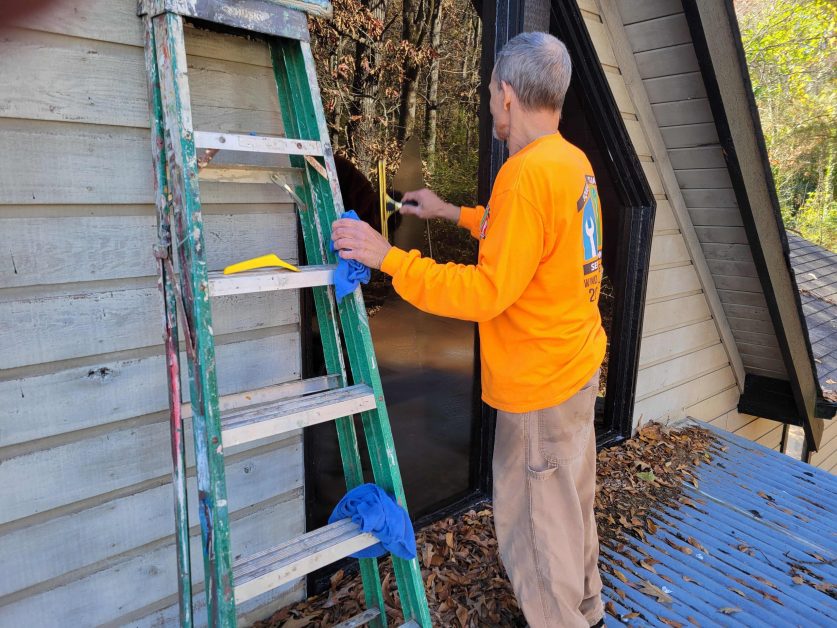 person taking care of window cleaning services
