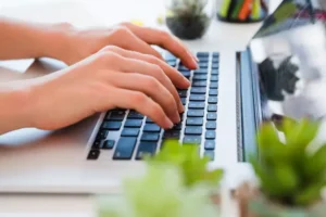 close up hands typing keyboard