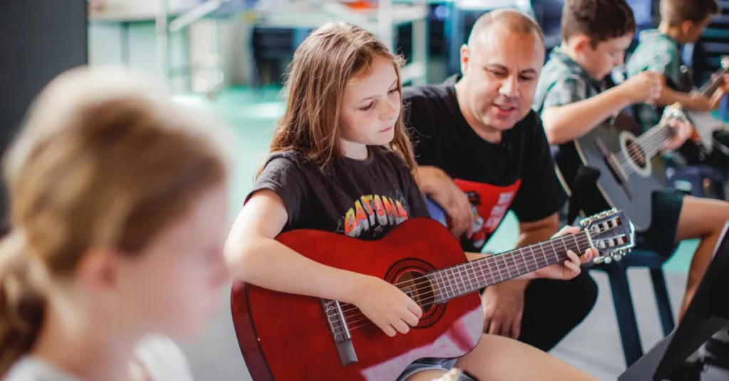 Kids group guitar lesson at a Gold Coast music school with teacher guidance